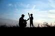 © Kostia - silhouette of father and son playing baseball on nature family sport