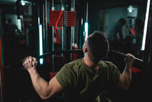 One Man Young Adult Caucasian Male Bodybuilder Training Back On The Cable Machine In The Gym Wearing Shirt Dark Photo Real People Copy Space Back View
