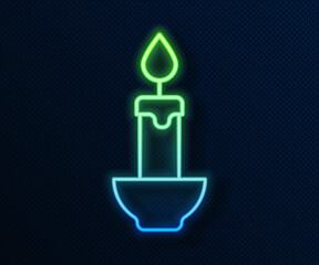 Sticker - Glowing neon line Burning candle icon isolated on blue background. Cylindrical candle stick with burning flame. Vector