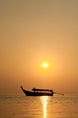 Wall Mural - Traditional Thai Boat Silhouetted at Sunrise at Tropical East Railay Beach, South Thailand, Southeast Asia