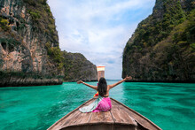 Happy Asian Woman Traveler Sit On A Long-tailed Boat Looking At Beautiful Natural Pileh Lagoon Krabi In Phi Phi Island. Sea Travel Phuket Thailand, Tourist Girl Relax On Summer Vacation.