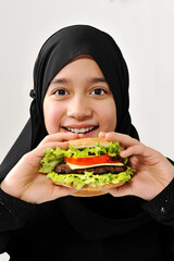 Wall Mural - Arabian girl eating burger , high quality photos