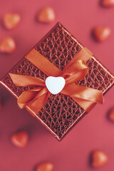 red gift box on the background of hearts for Valentine's Day