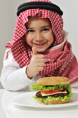 Cute kid with cheeseburger. High quality photo