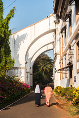 Wall Mural - Nuns walking through Old Goa, Goa, India