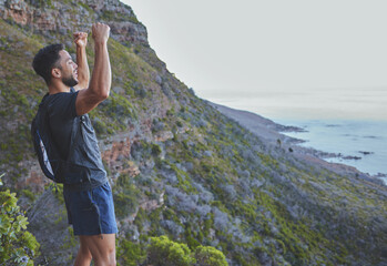 Poster - Always challenging myself to do better. Shot of a young man celebrating the completion of his hike at the top of the mountain.