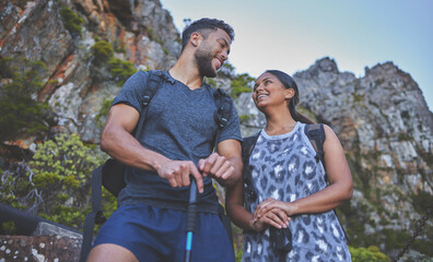 Poster - Spending time in nature with the most beautiful woman. Shot of a young couple hiking at sunset on a mountain range outdoors.