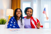 Two Happy African American Sister Celebrating Usa Independence Day At Home In Cozy Apartment