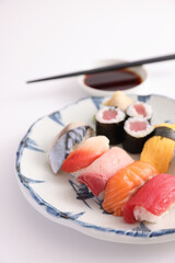 Wall Mural - Sushi Set nigiri and sushi rolls with soy sauce and chopsticks Japanese food isolated in white background