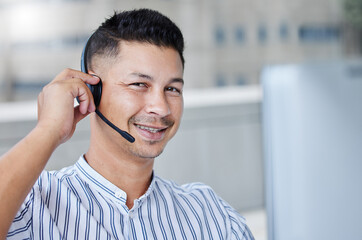 Poster - Yes we should be able to handle this no problem. Shot of a young businessman working in a call center office helping a client.