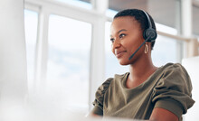 If You Need Us, Call. Shot Of A Woman Wearing A Headset While Working In A Call Centre.