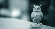 The Blue Form In The Form Of A Small Owl Created On A 3d Printer Stands On The Surface Of A Dark Blurry Background Close-up. Progressive Modern Additive Technologies 4.0 Industrial Revolution