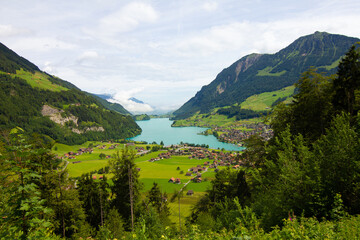 Wall Mural - Lake, mountains and village. Aerial view on village in Austria