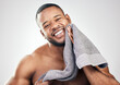 Fresh-faced and ready for the day. Studio portrait of a handsome young man wiping his face with a towel against a white background.