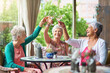 © Cecilie Skjold Wackerhausen/peopleimages.com - Cheers to a fun retirement with you girls. Cropped shot of a group of senior female friends enjoying a lunch date.