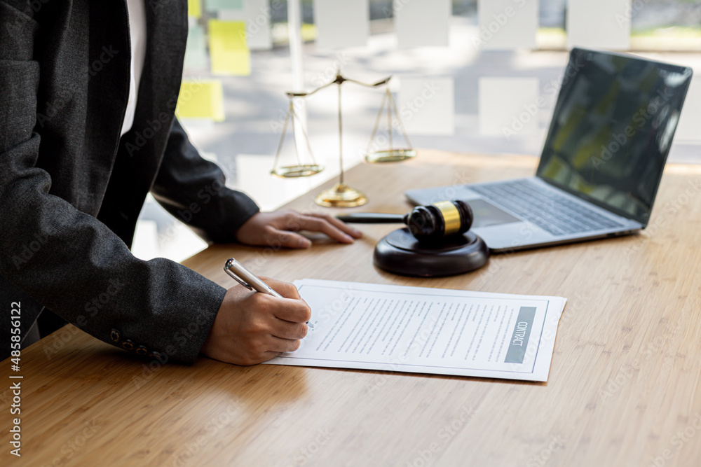Attorneys are reviewing contract documents for the client, in which the ...