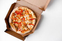 Hot Mexican Pizza In Cardboard Box For Delivery Or Take Away On White Solid Background