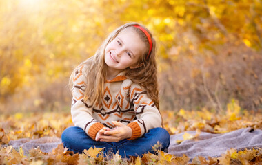 Wall Mural - Cheerful school girl in autumn park