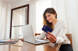 © carlos - happy young woman shopping online with credit card from home. High quality photo
