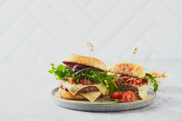 Wall Mural - Two burgers with veal cutlet and herbs on wooden cutting board