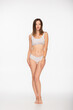 © LIGHTFIELD STUDIOS - full length view of barefoot woman in underwear looking at camera on white background