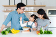 © 1112000 - image of an asian family cooking at home
