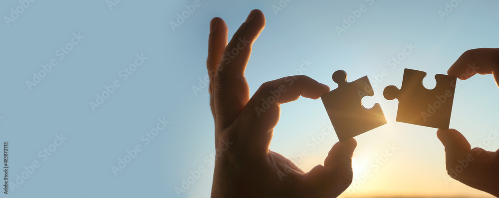 two hands of businessman to connect couple puzzle piece with sky ...