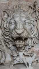 Wall Mural - Ancient figure of a fearful lion head in Rome, Italy, closeup, details.