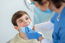 Close up of a young boy, male patient being tested for Covid-19
