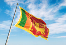 3d Rendering Sri Lanka Flag Waving In The Wind On Flagpole. Perspective Wiev Sri Lanka Flag Waving A Blue Cloudy Sky