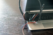 Headset on a laptop, wooden table. Call center, home office, customer support, help desk