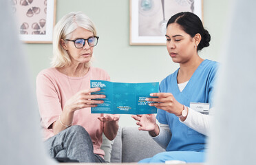 Wall Mural - Knowledge is the best defence. Shot of a female nurse reading through a Covid-19 pamphlet.