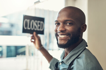 Aufkleber - Were ready to show you our new stock. Shot of a handsome young man standing and turning the sign on the door to his bicycle shop.