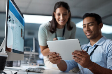 Growth comes from the kind of work you give. Shot of a young businessman and businesswoman using a digital tablet in a modern office.