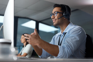 Aufkleber - Let me make that a little easier for you. Shot of a young man using a headset and computer in a modern office.