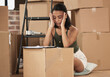 © Siphosethu Fanti/peopleimages.com - Moving deserves a vacation. Shot of a young woman having a stressful day during packing at home.