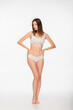 © LIGHTFIELD STUDIOS - full length view of barefoot woman in underwear standing with hands on hips on white background