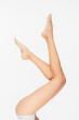 © LIGHTFIELD STUDIOS - cropped view of smooth and slim female legs isolated on white