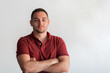 © .shock - Formal business male portrait. A confident successful casual businessman or manager stands in front of a white background, arms crossed, looking directly at the camera and smiling friendly. High