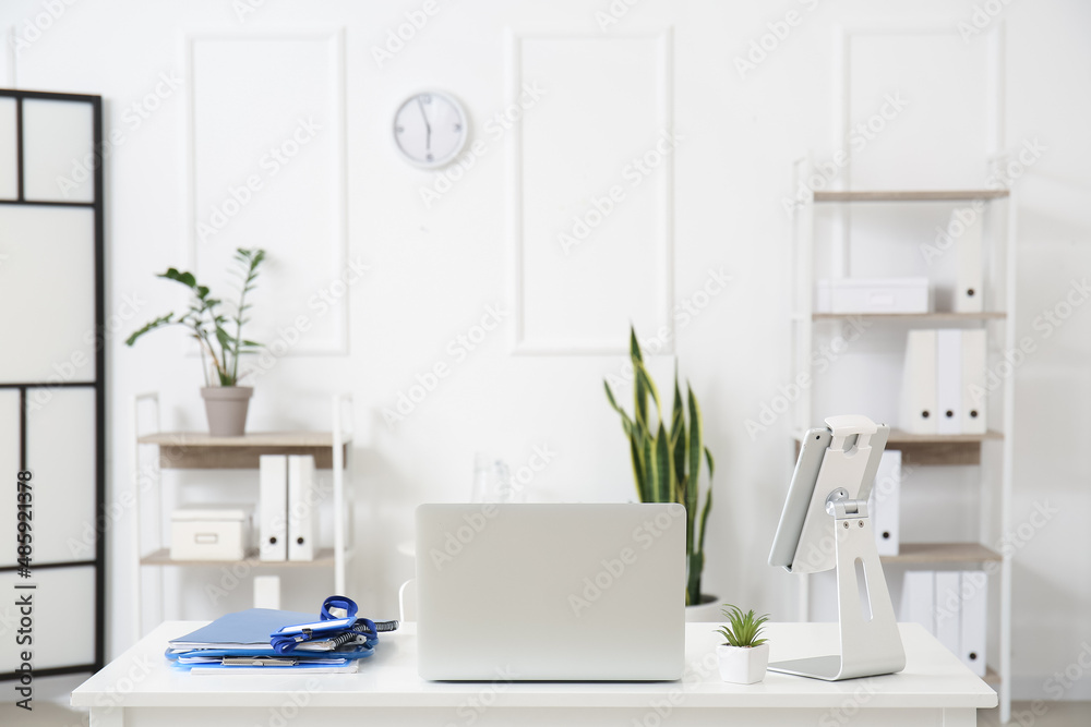 Modern doctor's workplace with laptop and tablet computer in medical office
