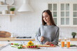 © BestForYou - Beautiful woman in the kitchen while preparing a vegetarian breakfast. Healthy eating.