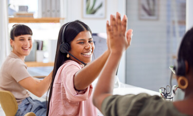 Aufkleber - We did it again. Shot of two businesspeople sharing a high-five while working in a call centre.