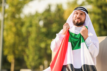 Wall Mural - Handsome Muslim man with UAE flag outdoors