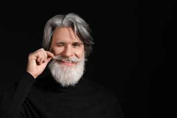 Canvas Print - Portrait of handsome mature bearded man on dark background