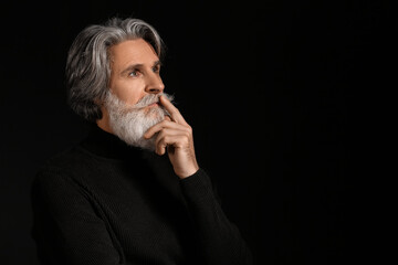 Poster - Portrait of handsome mature bearded man on dark background