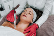 canvas print picture - Beautiful woman receiving microneedling rejuvenation treatment. Mesotherapy.