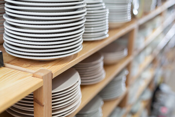 Wall Mural - Variety of plates displayed on shelving in household goods store. Kitchen utensils and dishware for sale