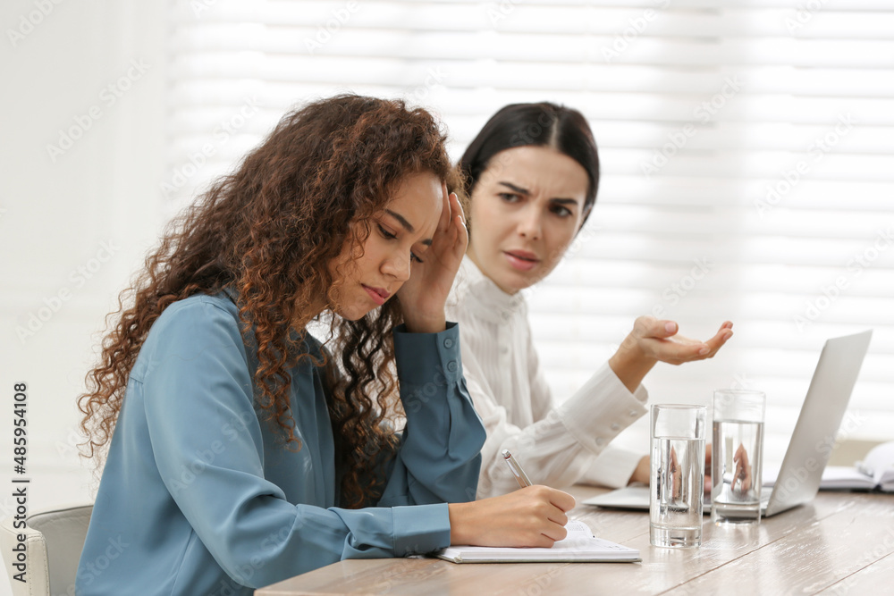 African American woman suffering from racial discrimination at work ...