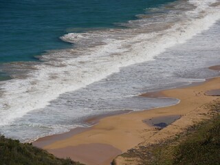 Wall Mural - Gentle waves rolling in toward a small beach in the Caribbean Islands