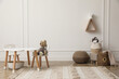 © New Africa - Cute child room interior with furniture, toys and wigwam shaped shelf on white wall